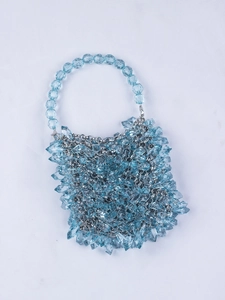 Detail of blue crystal bead handbag with transparent teardrop beads and silver chain link