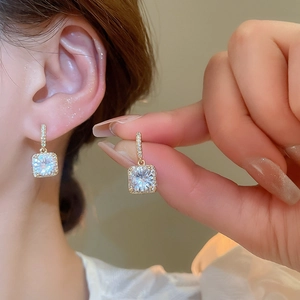 Detail shot of 18k gold plated square zircon earrings showing craftsmanship and sparkle