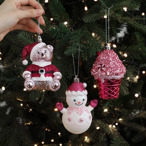 Pink and white glittery Christmas tree hanging ornaments in bear and snowman shapes