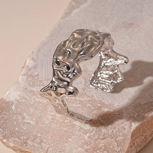Detail of silver irregular crumpled texture on molten liquid metal open cuff bracelet