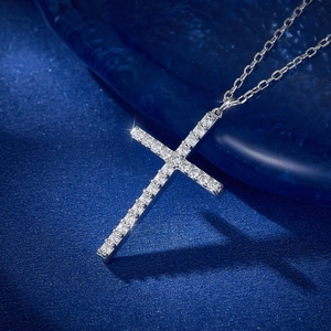 Elegant S925 sterling silver cross necklace with sparkling cubic zirconia on blue surface