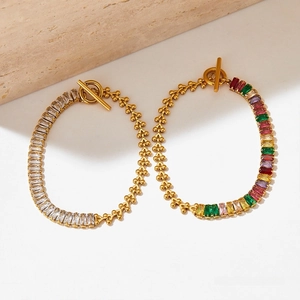 Detail of gold Cuban chain bracelet with rectangular zircon inlay and OT bar clasp