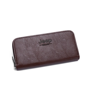 Macro detail of brown pebbled leather texture and metal zipper on men long wallet