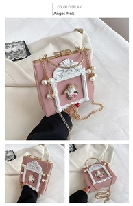 Detail of Angel Pink baroque relief bag featuring cherub carving and pearl chain