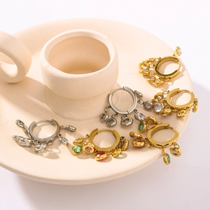 Detailed view of colorful zircon hoop earrings on a ceramic display