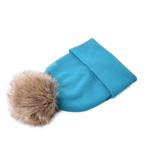Close-up of dark lake blue ribbed knit beanie with a large brown faux fur pom-pom detail