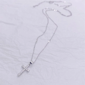 Detailed close-up of S925 sterling silver cross pendant with sparkling cubic zirconia