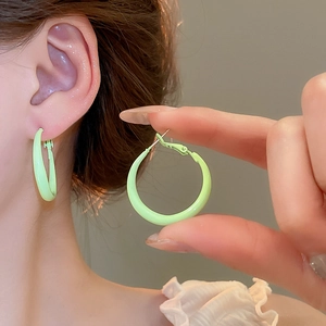 Macro detail of mint green hoop earring showing smooth surface and minimalist circle design