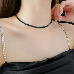 Close-up of minimalist black beaded crystal necklace on model for a stylish look