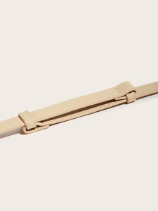 Detail of beige Saffiano leather belt featuring refined stitching and a wide shoulder pad