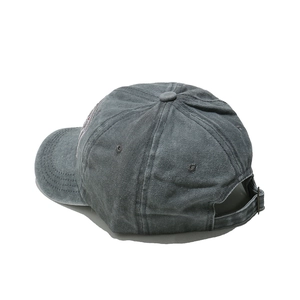 Detail of vintage washed gray baseball cap showing side embroidery and metal buckle strap