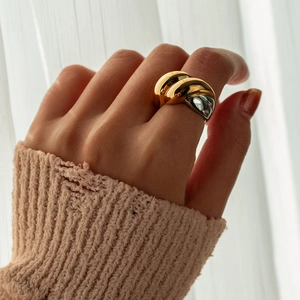 Detail of two-tone gold and silver minimalist ring with polished mirror finish on model