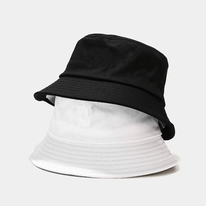 Detailed view of black and white cotton bucket hats featuring multi-row stitched brims