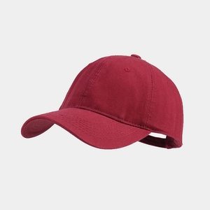 Detailed side view of high-quality cotton baseball cap in deep burgundy wine red