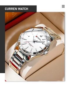Detailed close-up of CURREN men's two-tone steel watch on display cushion with 24-hour bezel