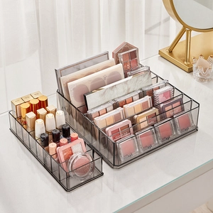 Clear plastic makeup organizer for lipstick and eyeshadow on a vanity table setup
