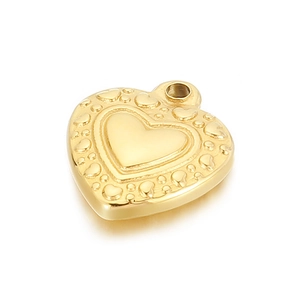 Close-up of golden heart pendant with embossed heart pattern on a clean white background