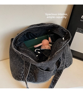 Detail shot of the large capacity dark denim tote bag interior showing daily essentials
