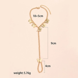 Detail view of gold butterfly finger bracelet chain with precise size and weight measurements