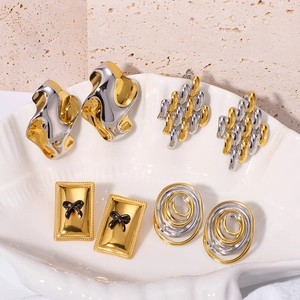 Two-tone geometric 18K gold plated earrings collection on white shell tray