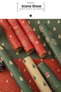 Close-up of Christmas kraft wrapping paper rolls with festive snowflake and tree patterns
