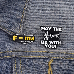 Macro shot of physical formula enamel pins pinned on a blue denim jacket pocket