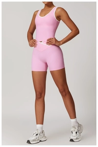 Detail view of pink yoga set with white contrast trim and V-shaped crossover high waist shorts