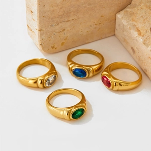 Detailed display of colorful oval gemstones set in gold-plated stainless steel rings