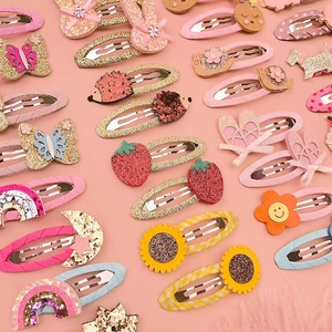 Close-up of cute cartoon hair clips with sequins and animal patterns for girls