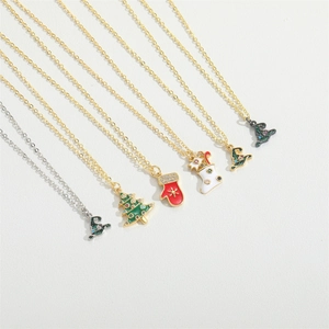 Flat lay of six Christmas necklaces featuring gold and silver chains with enamel pendants