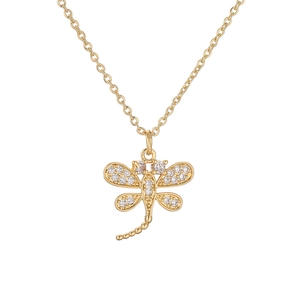 Macro detail of gold dragonfly pendant encrusted with sparkling white cubic zirconia