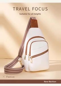 Detail of white pebbled leather crossbody bag with striped strap and gold hardware