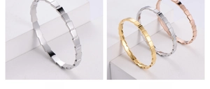 Macro view of geometric faceted bracelets in silver, gold and rose gold finishes