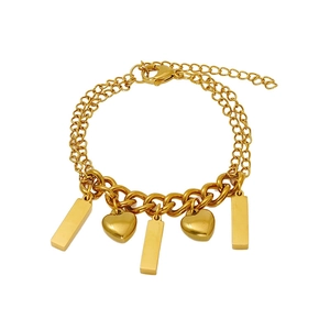 Dettaglio del bracciale a doppia catena placcato oro 18K con ciondoli a cuore e barra