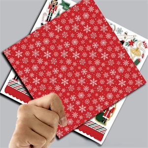 Close-up of Nutcracker ballet papers with red snowflake patterns for scrapbooking