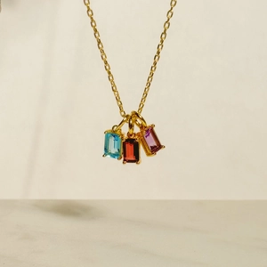 Detailed view of 18K gold plated necklace with blue, red, and purple zircon stones