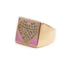 Macro detail of golden square ring with pink enamel heart and zircon inlay