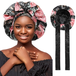 Detail of floral black satin sleep bonnet with adjustable long ribbons and bow