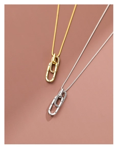 Detailed macro of interlocking double ring pendant in gold and silver with Forever engraving