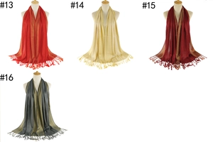 Detailed view of four elegant tassel scarves in red, champagne, burgundy and grey colors