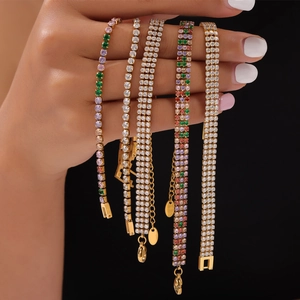 Elegant gold titanium bracelets with colorful zircons in multiple rows on black background