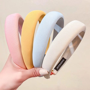 Set of four ribbed sponge headbands in pink, yellow, blue, and beige colors