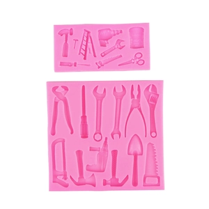 Pink silicone fondant mold featuring detailed hardware tool shapes like hammers and drills