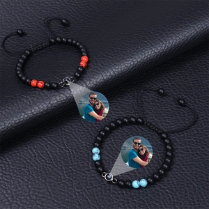 Custom photo projection bracelet with matte tiger eye beads on black leather background