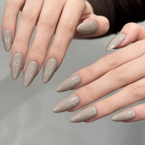 Minimalist grey almond press-on nails with a glossy finish on a clean grey background