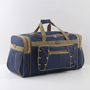 Detail view of large blue travel bag with khaki trim and elastic cord front pocket