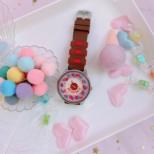 Pink biscuit dial watch with brown silicone strap surrounded by cute candy decor