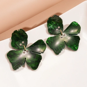 Close-up of green marble resin flower earrings with delicate rhinestone details