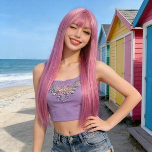 Long pink straight hair wig with bangs styled for women on a bright beach background