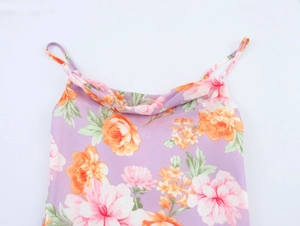 Detailed view of cowl neck and purple floral print on a sleeveless summer dress